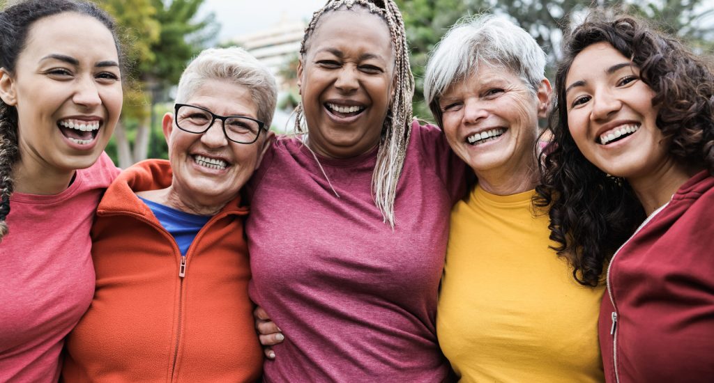 Happy multi generational women having fun together after sport workout outdoor - Focus on african senior woman face